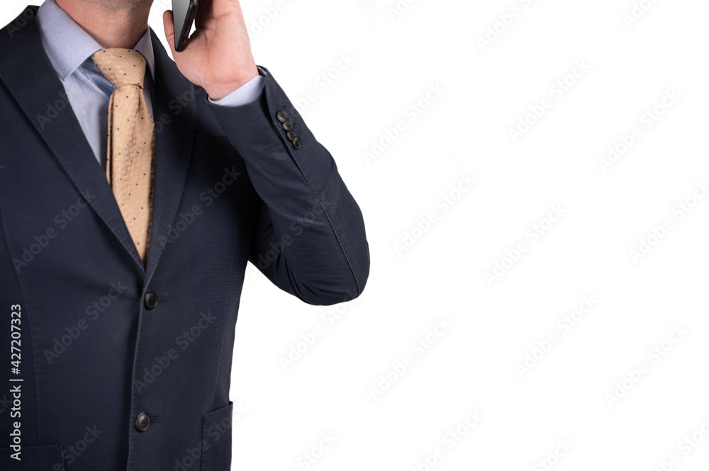 businessman talking on cell phone. face is not visible. man in a suit holds a mobile phone in his hand. isilated on white