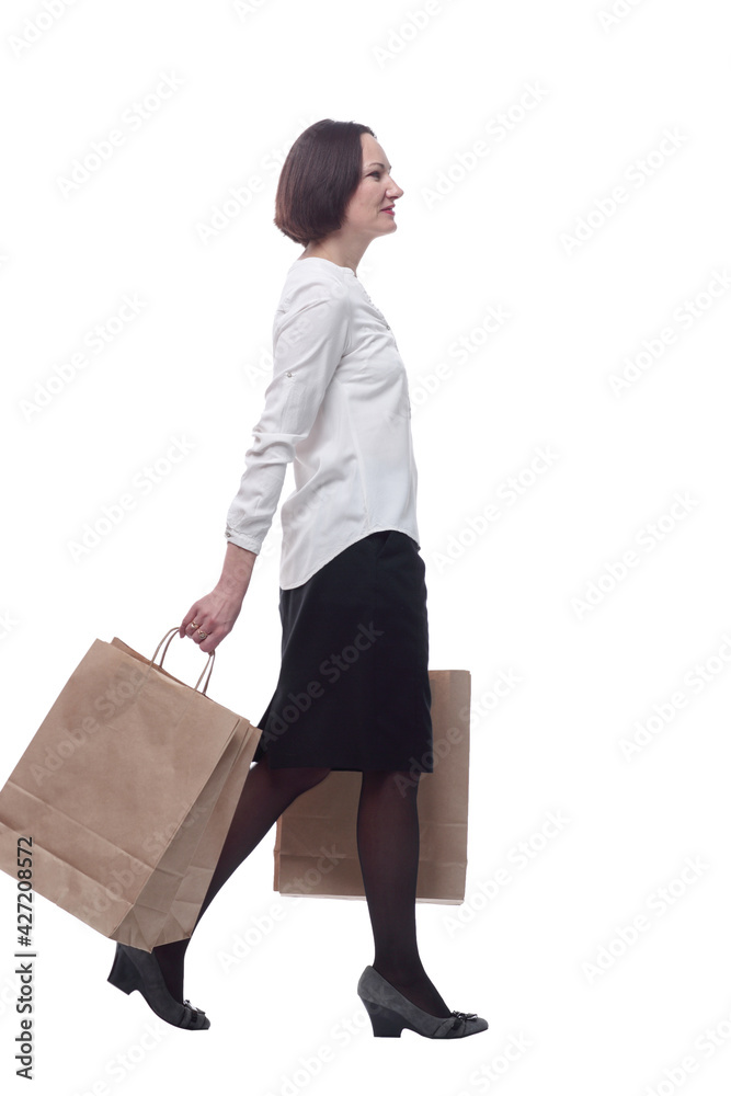 adult woman with shopping bags striding forward . adult woman with shopping bags striding forward .