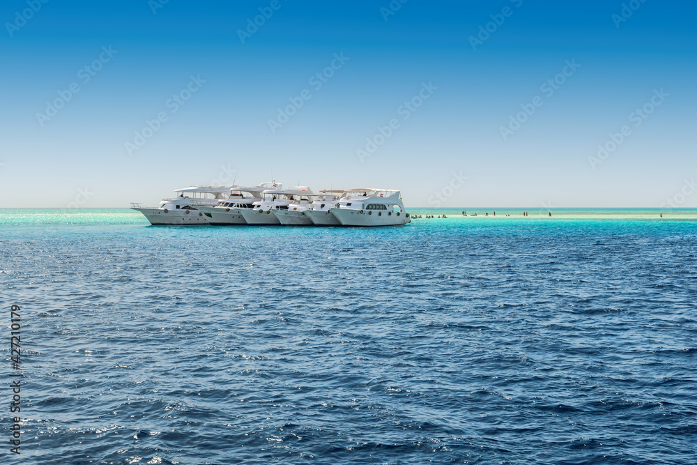 Luxury yachts in cruise on tropical beach in Sunny summer island, Red Sea, Egypt
