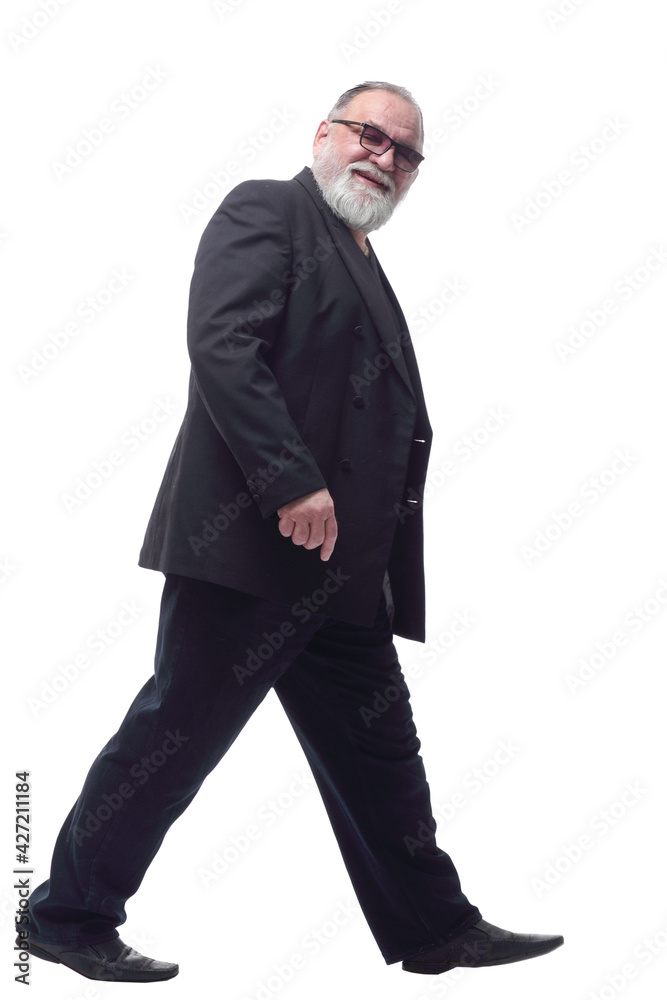 satisfied man in a business suit striding forward .