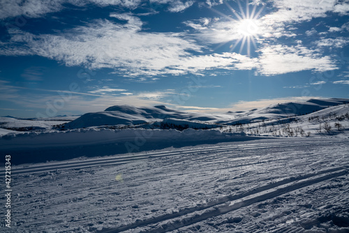 Cross country skiing tracks in a Nordic mountain terrain on a cold sunny winters day.