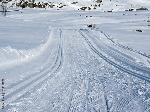 Cross country skiing tracks in a Nordic mountain terrain on a cold sunny winters day. © henjon