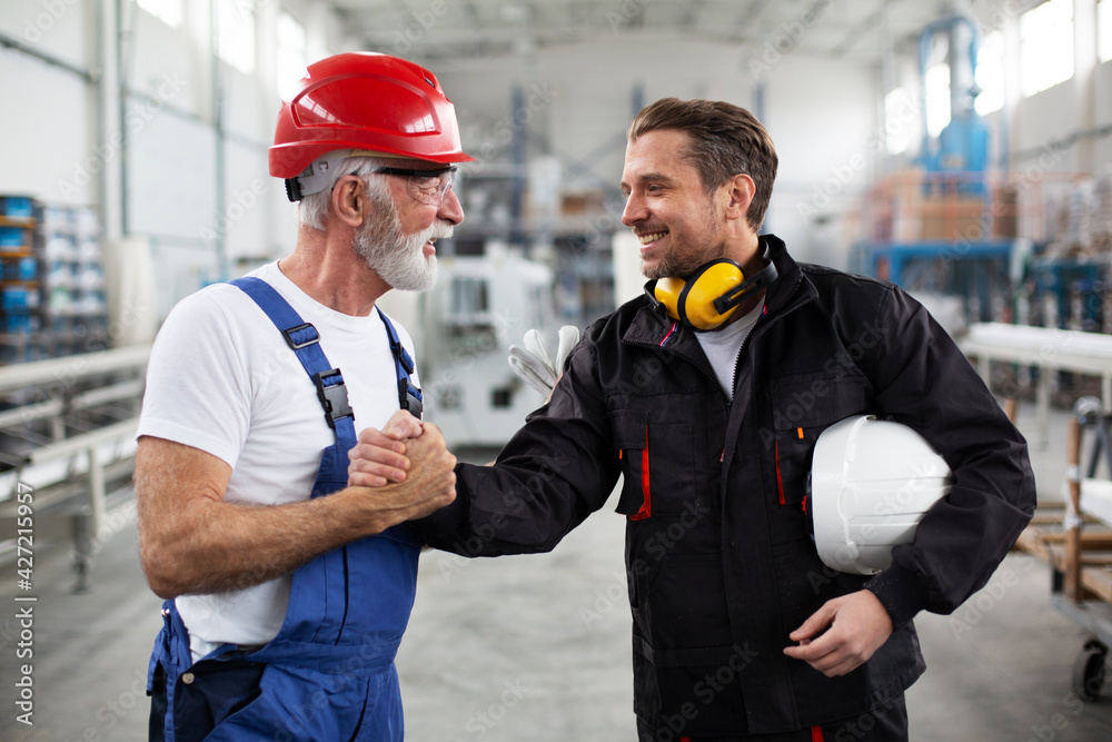 Workers in factory. Happy colleagues working in factory. Workers in factory. Happy colleagues working in factory.
