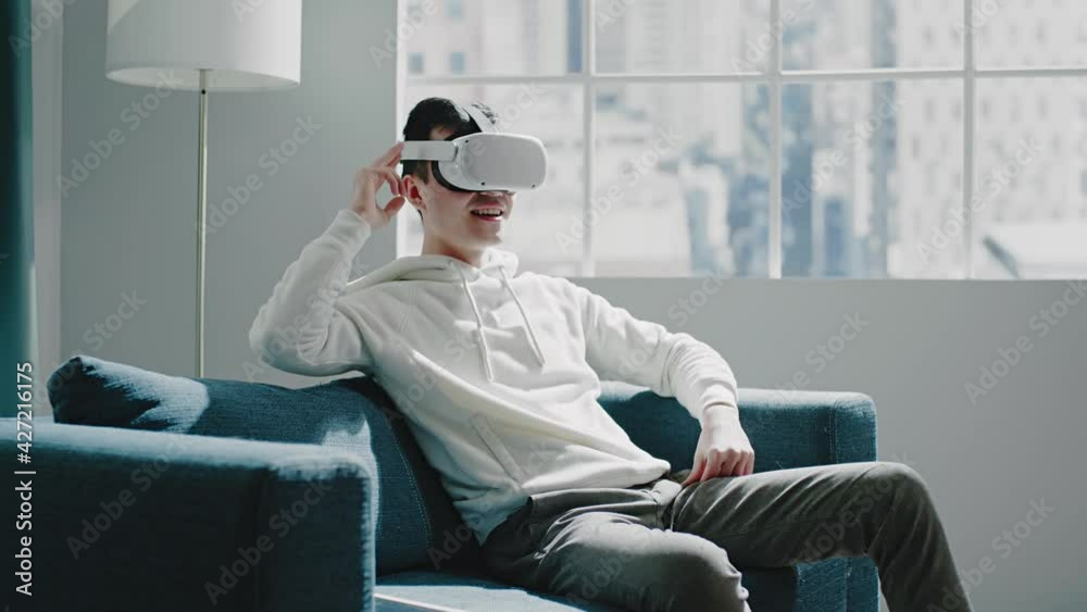 Smiling Asian virtual reality developer swipes simulations