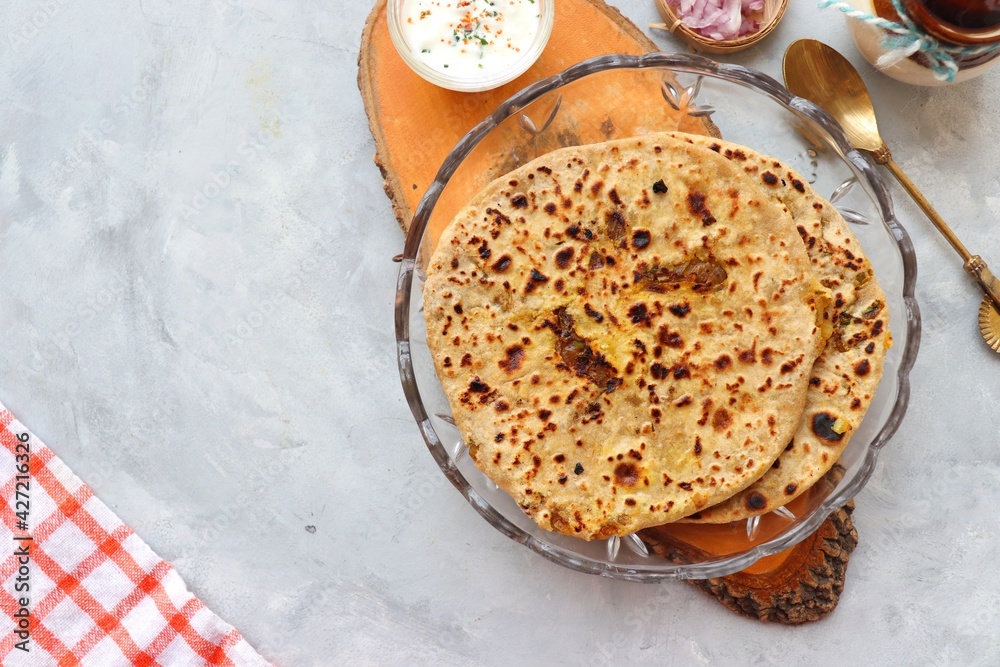 Indian traditional Hot Onion Paratha with yogurt. Indian onion stuffed
