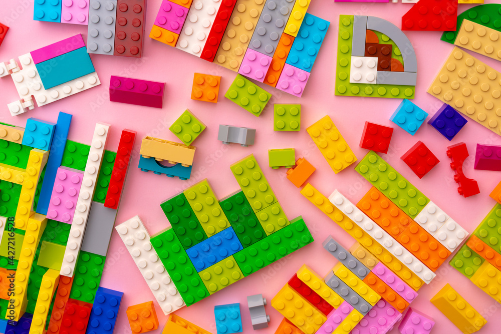 Plastic constructor details on pink background close up Plastic constructor details on pink background close up