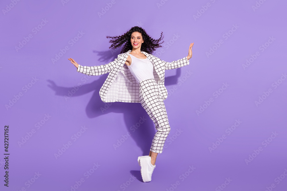 Full body profile side photo of young attractive woman happy positive smile look empty space isolated over violet color background Full body profile side photo of young attractive woman happy positive smile look empty space isolated over violet color background