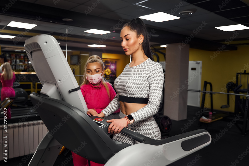 Young healthy woman cardio on a treadmill at the gym Young healthy woman cardio on a treadmill at the gym
