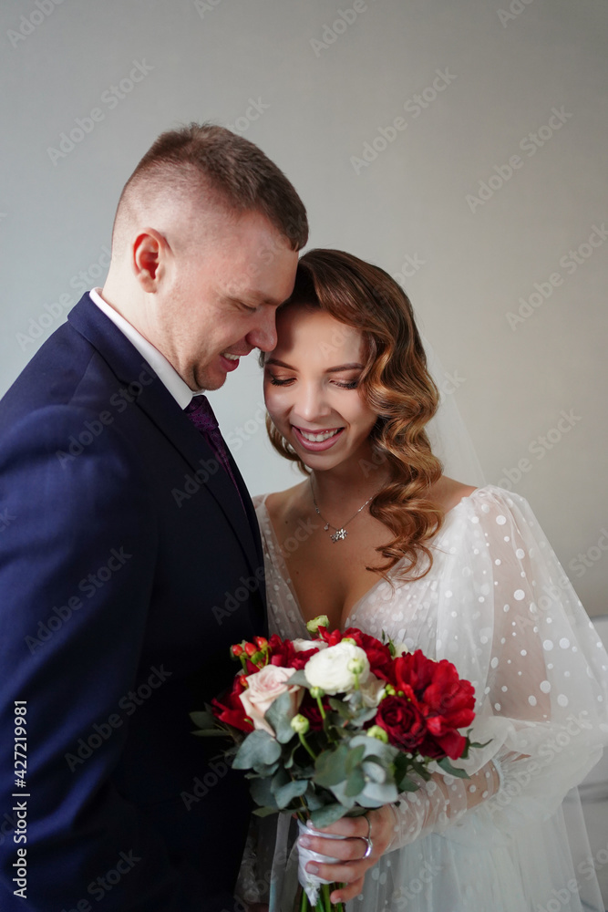  The groom with a bouquet of flowers for the bride on the wedding day. 