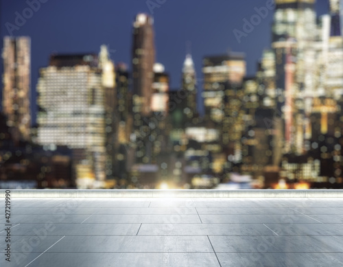 Empty concrete rooftop on the background of a beautiful blurry New York city skyline at evening, mock up © Pixels Hunter