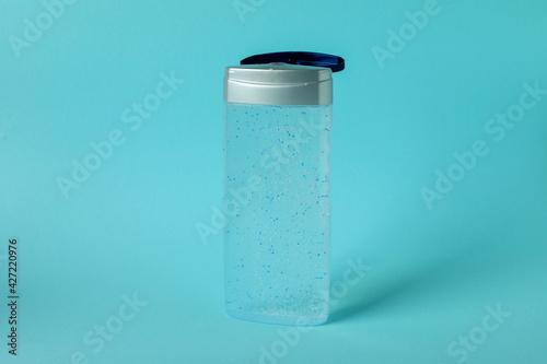 Blank bottle of shower gel on blue background