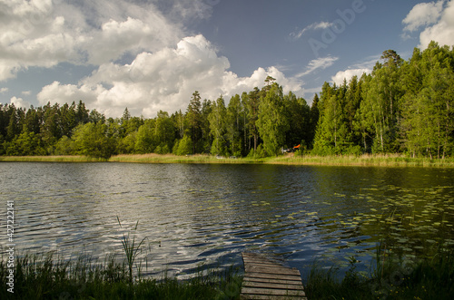 Fototapeta Naklejka Na Ścianę i Meble -  Beautiful evening view with lake, reflections in the water and clouds.