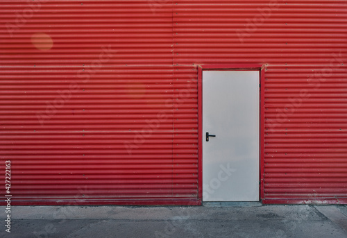 White door in a red wall