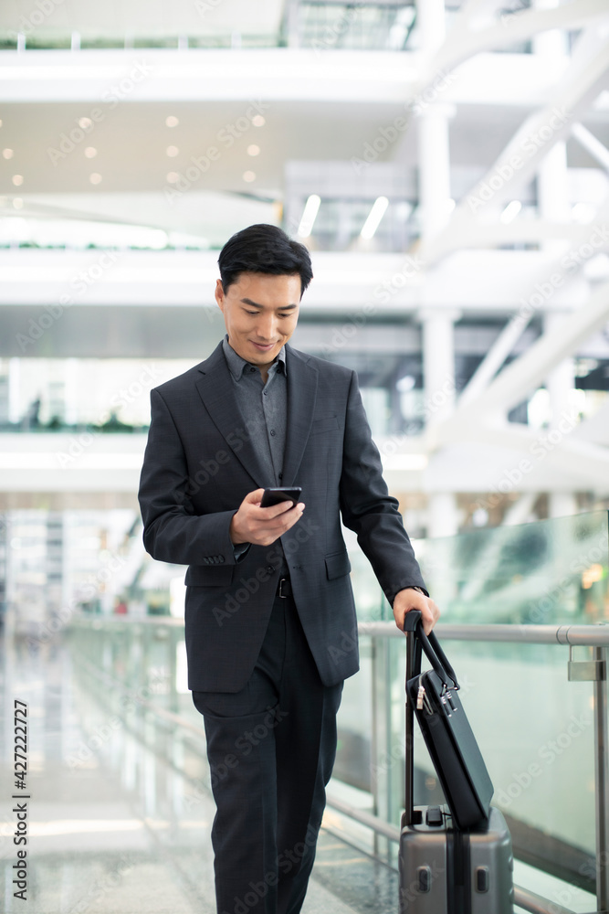 Successful businessman using smartphone at airport Successful businessman using smartphone at airport