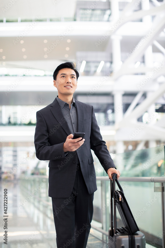 Successful businessman using smartphone at airport Successful businessman using smartphone at airport