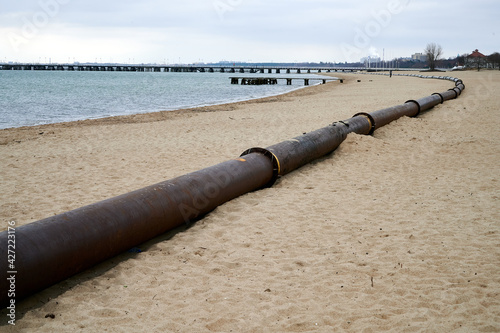 Fotografiet Pressure silting pipes on the beach of Sopot