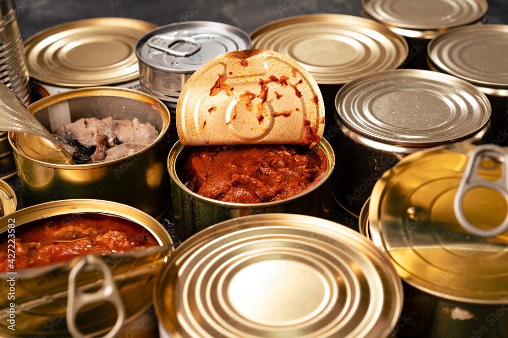 Many cans with conserved fish on wooden table Many cans with conserved fish on wooden table
