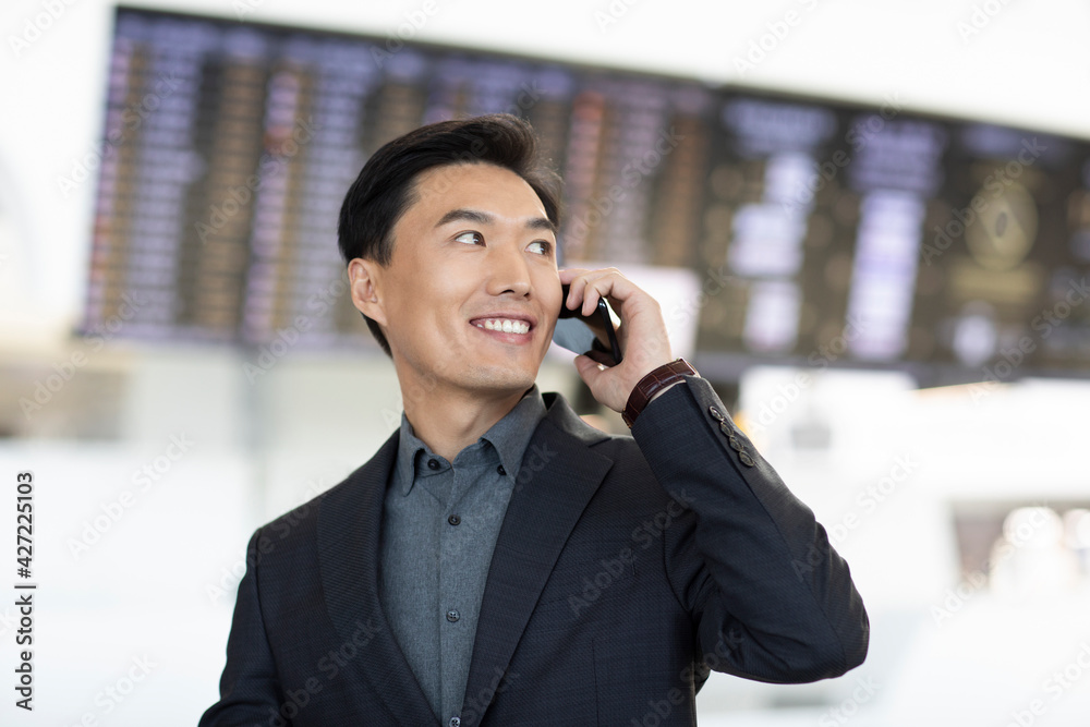 Successful businessman using smartphone at airport Successful businessman using smartphone at airport