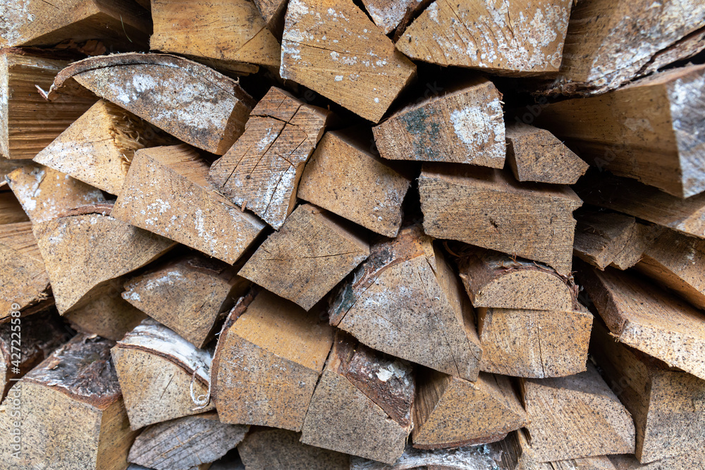 Woodpile. Firewood prepared for heating the premises in the cold season. Close-up. Woodpile. Firewood prepared for heating the premises in the cold season. Close-up.