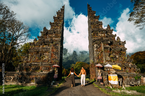 Beautiful couple at the Baltic temple. Man and woman traveling in Indonesia. Couple at the Bali gate. The couple travels the world. Travel to tourist places in Asia. Tourists in Bali. Copy space. photo