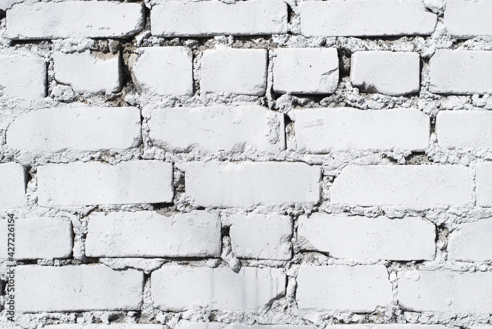 Textured background of a brick wall painted with white paint, close-up. Backdrop Textured background of a brick wall painted with white paint, close-up. Backdrop
