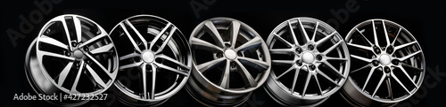 black beautiful sports alloy wheels forged stand in a row on a black background