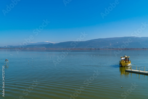 Ottoman-themed tourist boat on Lake Ulubat in Gölyazi, Bursa, Turkey with snow-capped mountains