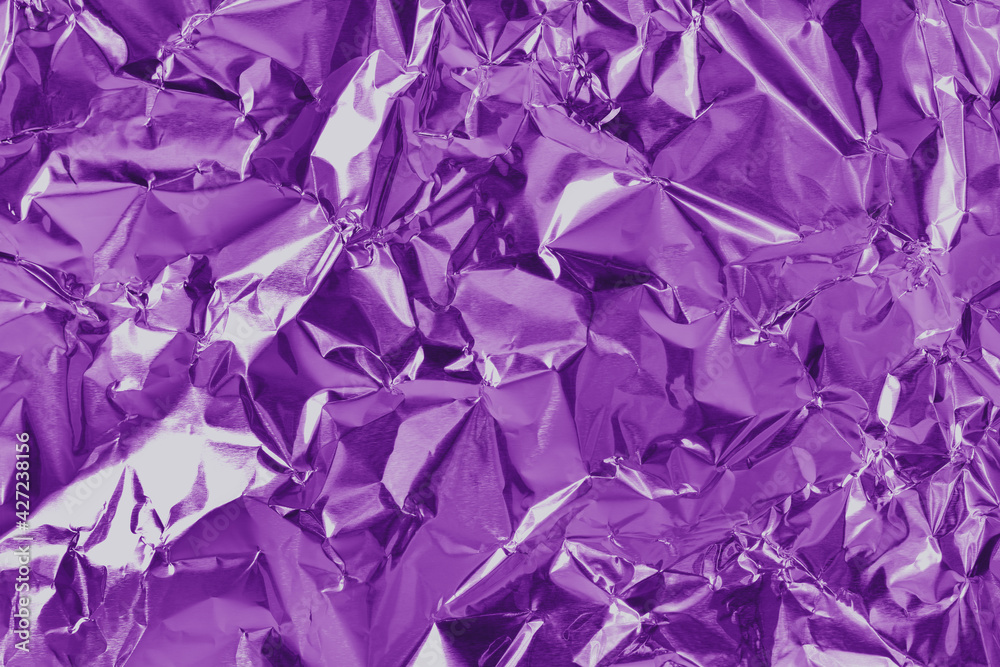 Purple metallic foil shiny texture, wrinkled wrapping paper for background and design art work.