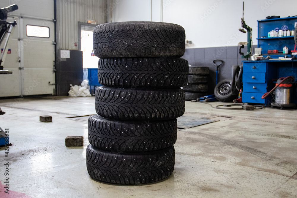 Obraz premium Five car tires at a tire service. Tire fitting company