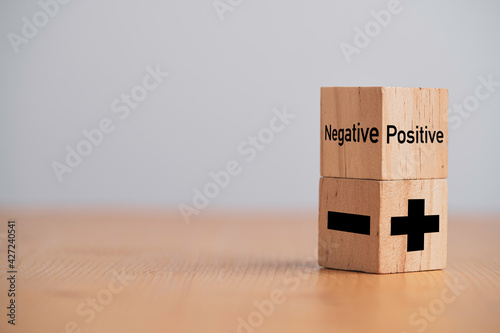 Plus and minus sign on wooden cube block ,Positive and negative thinking and mindset concept.