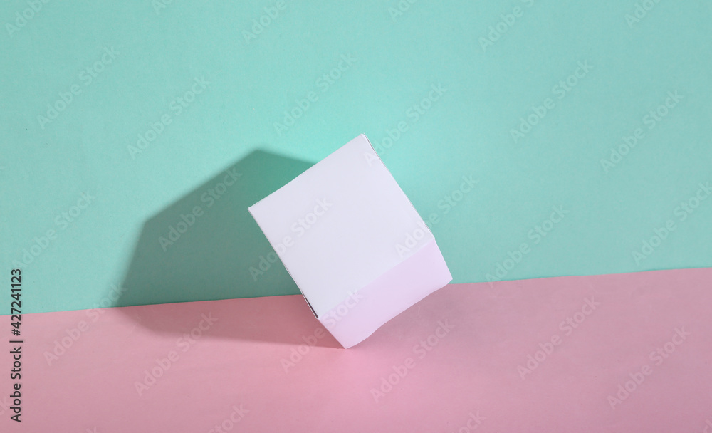 White cube on blue-pink pastel background. Minimalism. Trendy shadow. Creative layout. White cube on blue-pink pastel background. Minimalism. Trendy shadow. Creative layout.