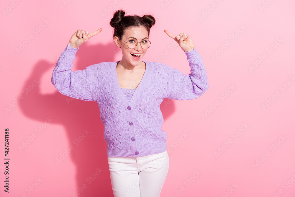 Photo portrait of funky girl showing fingers on hairstyle smiling happy isolated on pastel pink color background