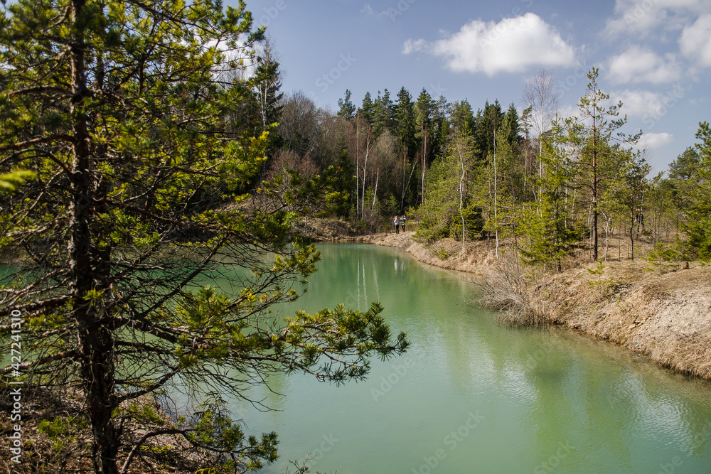 Obraz premium View of small green blue Lackroga lake, Latvia
