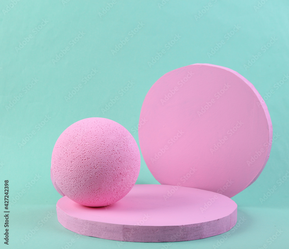 Pink podium on blue floor. Platforms for product presentation and ball, mock up background. Abstract composition in minimal design, pastel colors trend. Geometric shapes. Pink podium on blue floor. Platforms for product presentation and ball, mock up background. Abstract composition in minimal design, pastel colors trend. Geometric shapes.