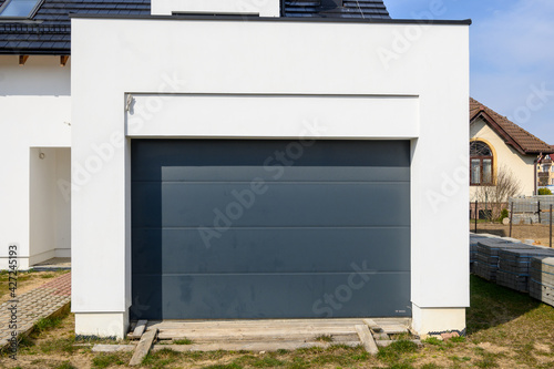 Modern door garage in contemporary house. House under construction. Europe