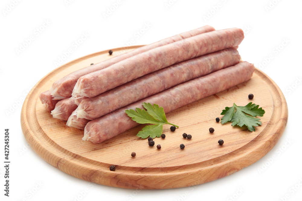 Raw sausage on cutting board isolated on white Raw sausage on cutting board isolated on white