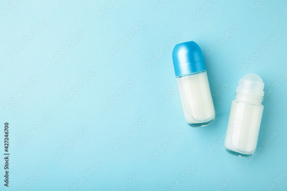 Different deodorants on blue background, top view. Skin care Different deodorants on blue background, top view. Skin care