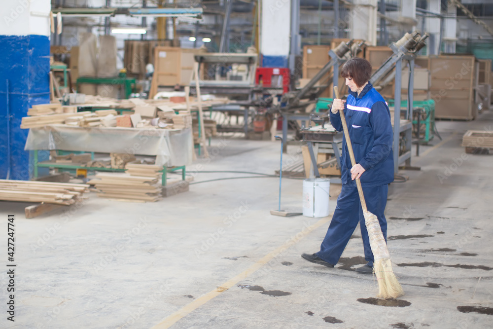 Cleaning woman at the factory Cleaning woman at the factory
