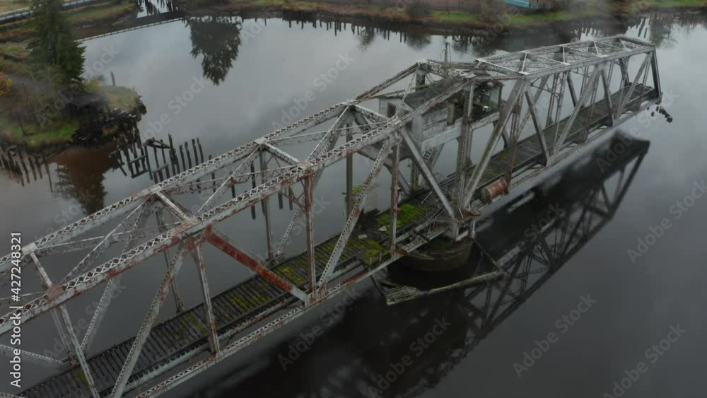 Old abandoned metal swing bridge in the middle of the lake in Washington, USA Old abandoned metal swing bridge in the middle of the lake in Washington, USA