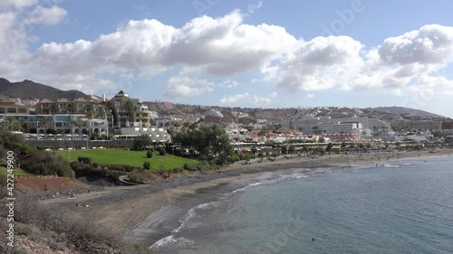 View of the Fanabe beach in Costa Adeje. Tenerife. Canary Islands. Spain, background blue sky with clouds photo