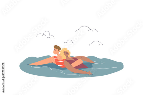 Beach lifeguard saving unconscious woman drowning in sea while seaside vacation