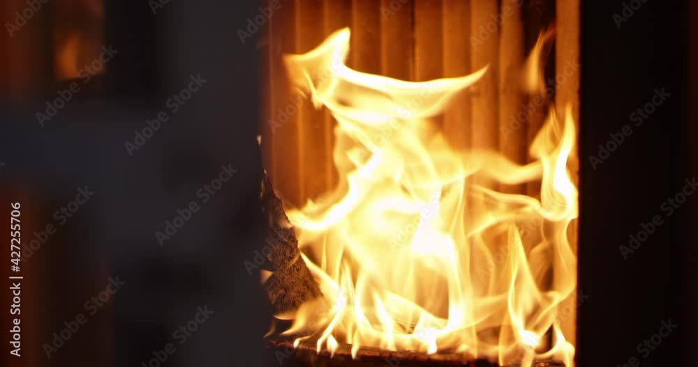 Openning fireplace and throwind wooden log into fire flames, slow motion
