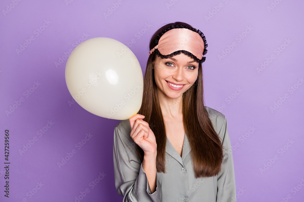 Photo portrait of dreamy woman in pajama keeping white air balloon isolated on pastel violet color background Photo portrait of dreamy woman in pajama keeping white air balloon isolated on pastel violet color background
