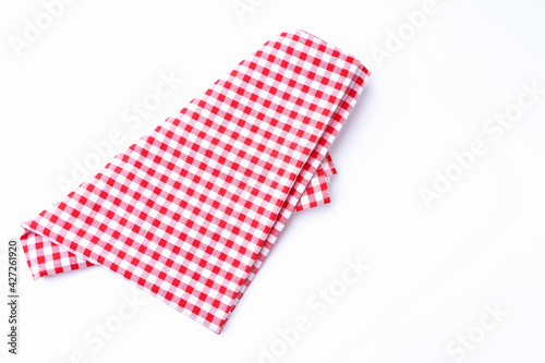 Red and white fabric tablecloth checkered on white background with copy space...