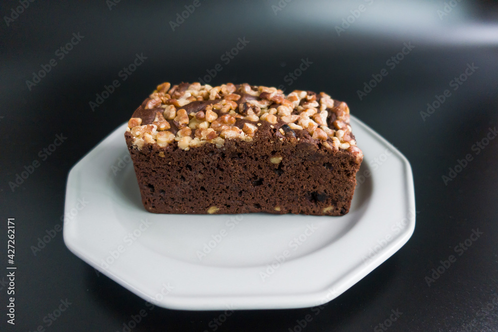 Brownies with walnut on the black background.