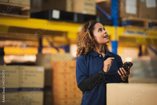 African American worker in warehouse, woman manager checking the store stock, business industry storage report working in warehouse, logistic online shipping service concept photo