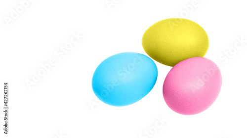 Colorful easter eggs (blue, yellow, pink) for decoration isolated on white background with copy space. Close up photo.