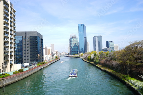Osaka skyline along with Neya river (Neyagawa) in Japan . Panoramic view. - 日本 大阪府 寝屋川 大阪のビル 水上バス