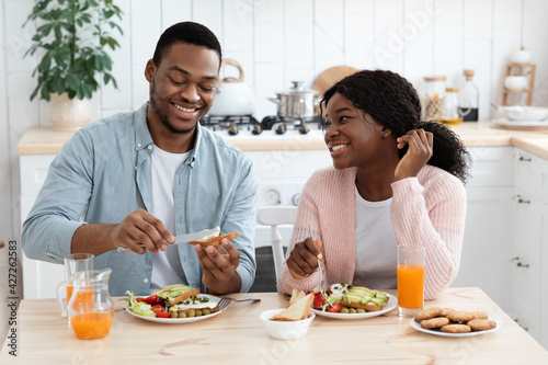 Morning Meal. Portrait Of Cheerful Black Couple Enjoying Tasty Breakfast In Kitchen