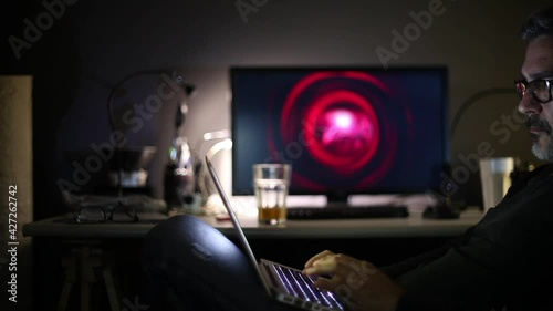 Man With Glasses Working on Computer Or Tablet